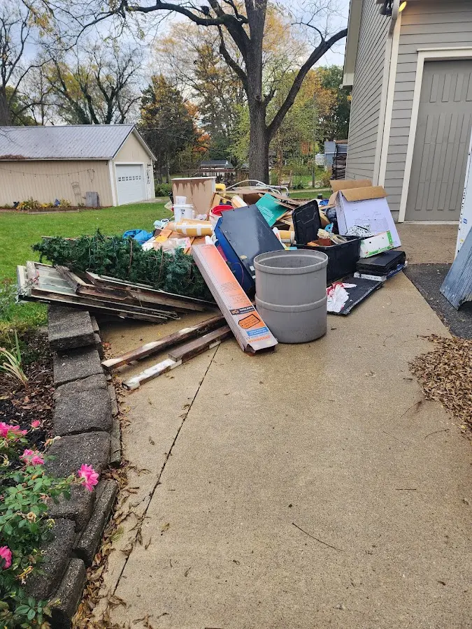 Dumpster being loaded with debris for Estate Cleanout Dumpster Rental in Mount Morris